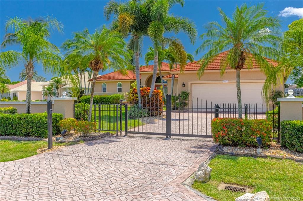 2642 Northwest S Shore Road Stuart, FL 34994 - Photo 5 of 40 a view of a house with a yard and potted plants