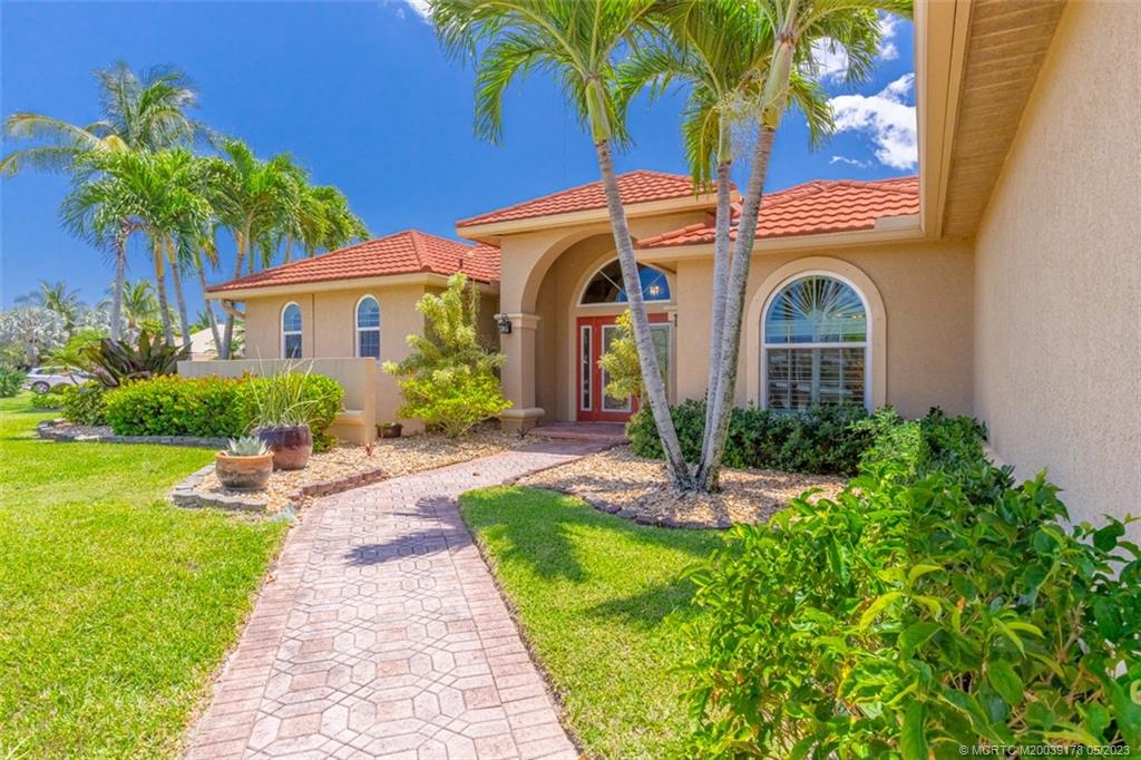 2642 Northwest S Shore Road Stuart, FL 34994 - Photo 7 of 40 a front view of a house with garden