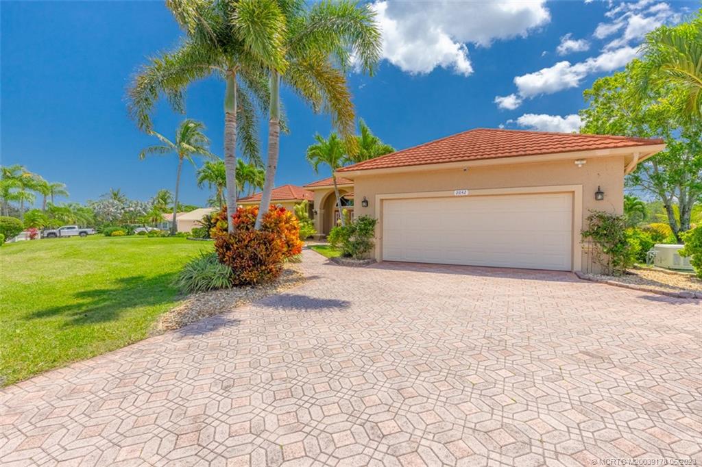2642 Northwest S Shore Road Stuart, FL 34994 - Photo 8 of 40 a front view of a house with garden