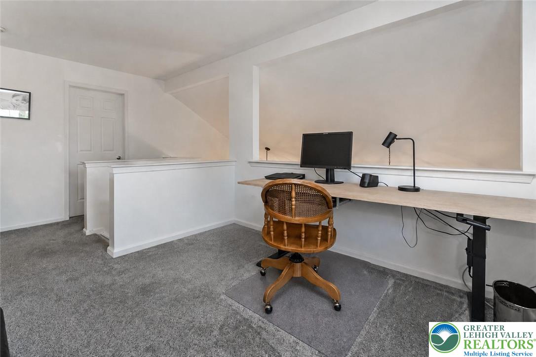 2314 Red Maple Drive Coplay, PA 18037 - Photo 28 of 73 A well-lit, dedicated work-from-home space features a spacious built-in desk with carpeted flooring.