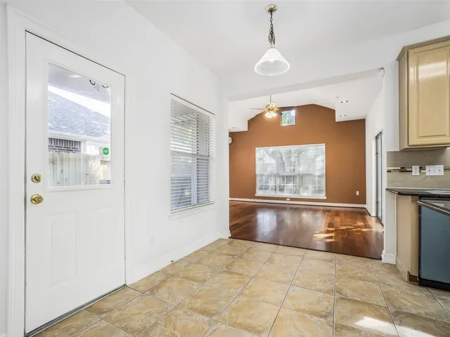 a view of an empty room with a kitchen
