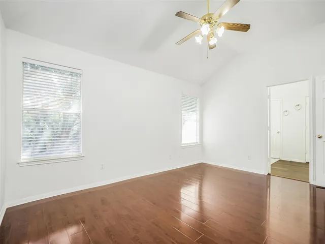 wooden floor in an empty room with a window
