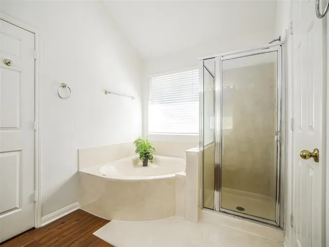 a bathroom with a bathtub and a shower