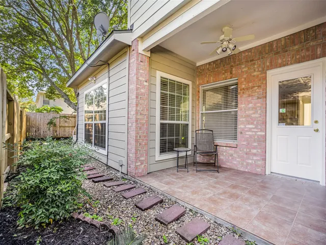 a backyard of a house with outdoor seating