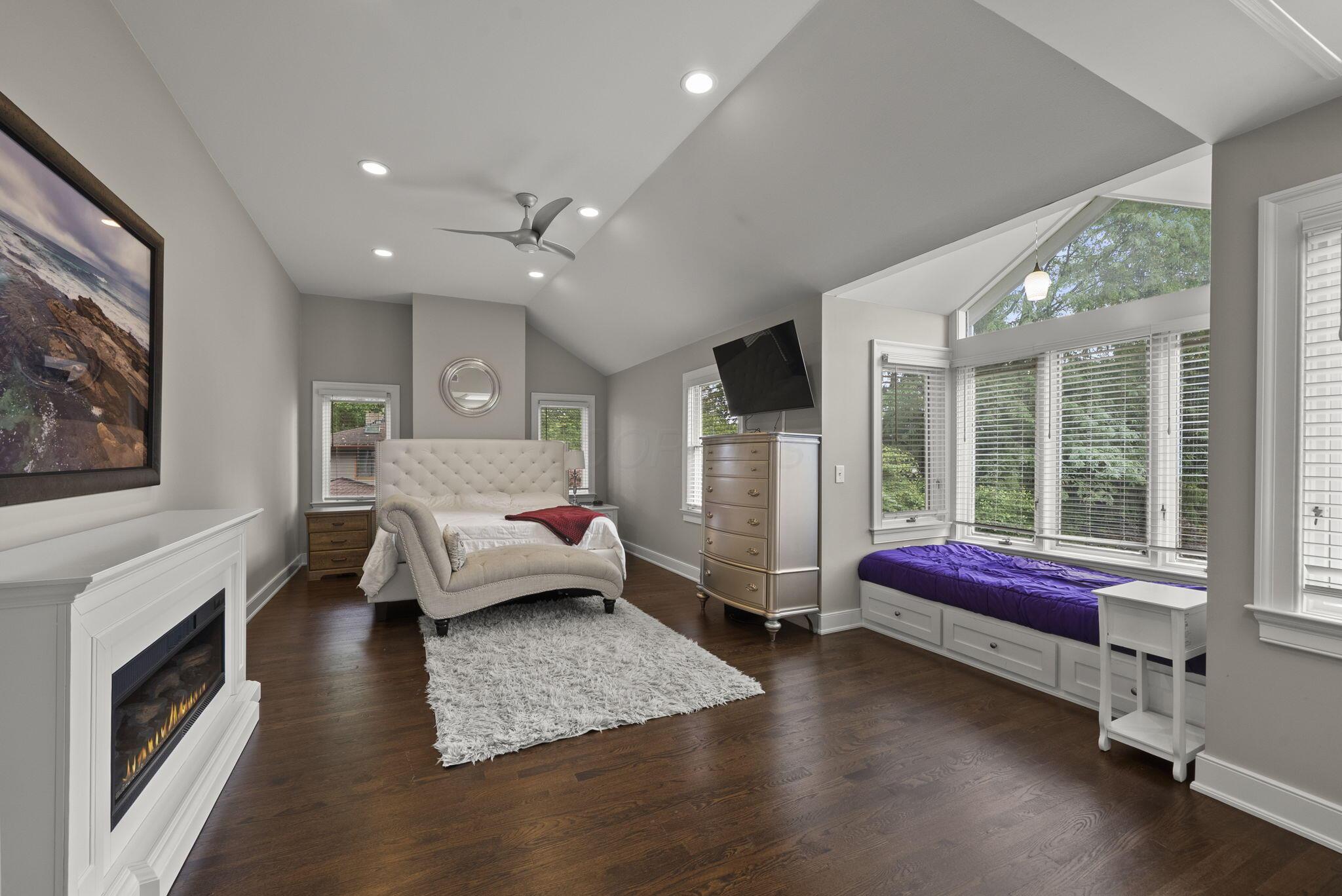 1851 Berkshire Road Columbus, OH 43221 - Photo 30 of 125 Spacious primary bedroom, high ceilings, ample light, featuring skylight, reading space or day bed overlooking the backyard.