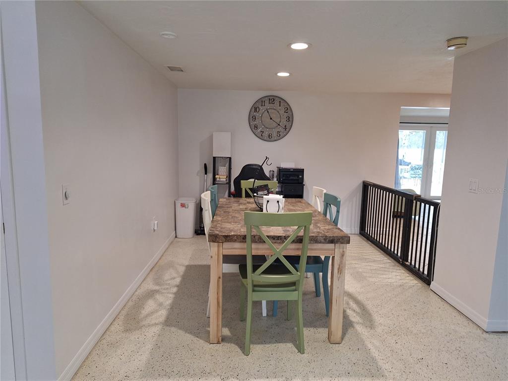 9415 Indale Drive New Port Richey, FL 34654 - Photo 15 of 93 a view of a dining room and livingroom with furniture and a window