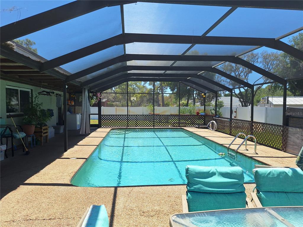 9415 Indale Drive New Port Richey, FL 34654 - Photo 28 of 93 a view of a backyard with lots of tables and chairs