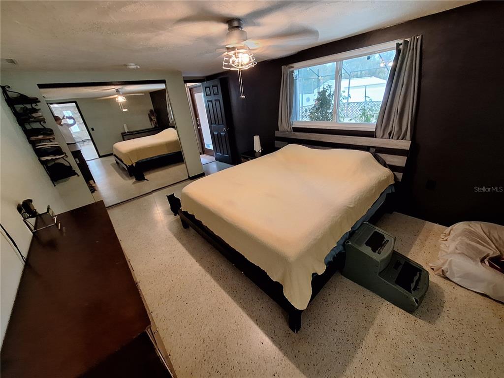 9415 Indale Drive New Port Richey, FL 34654 - Photo 32 of 93 a bed room with a bed window and furniture