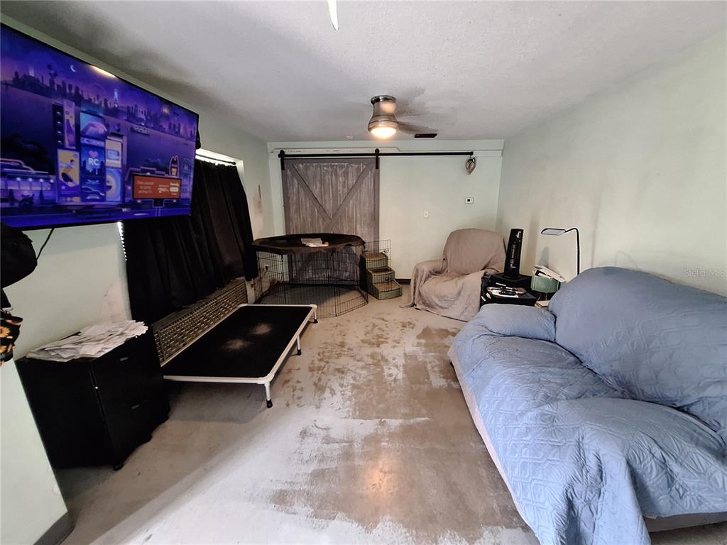 9415 Indale Drive New Port Richey, FL 34654 - Photo 76 of 93 a living room with furniture and a flat screen tv