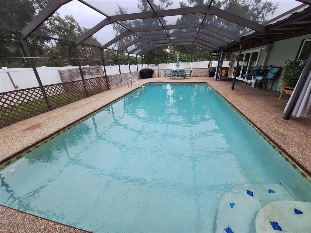 9415 Indale Drive New Port Richey, FL 34654 - Photo 87 of 93 a view of a swimming pool with a patio