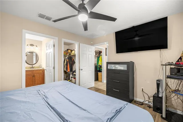 a bedroom with a bed and a flat screen tv