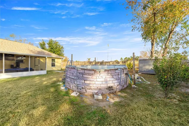 a view of a house with a backyard porch and sitting area