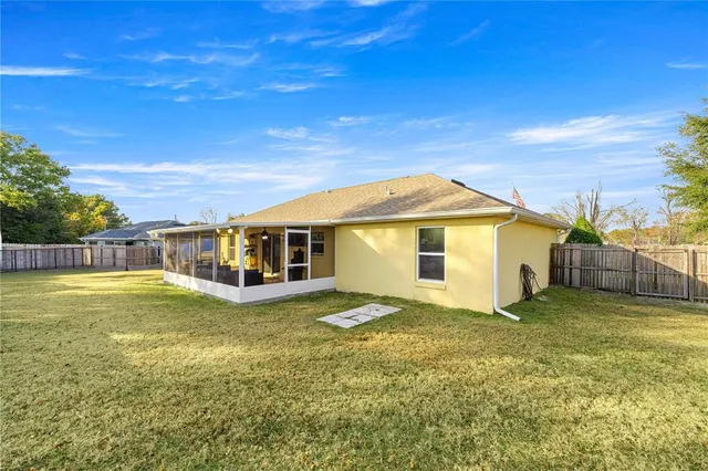 a view of a house next to a big yard