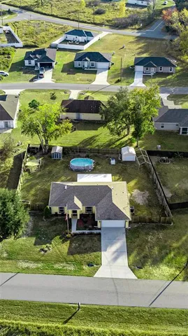 a view of a swimming pool with a yard