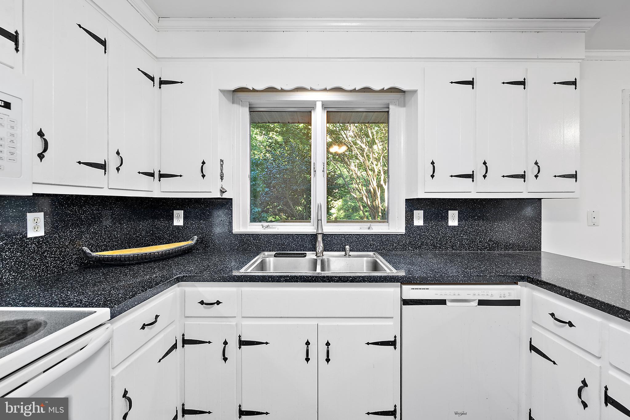 6181 Rockawalkin Road Salisbury, MD 21801 - Photo 19 of 65 a kitchen with granite countertop a sink and a stove