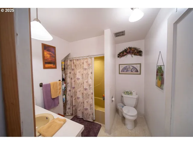 a bathroom with a toilet sink and shower