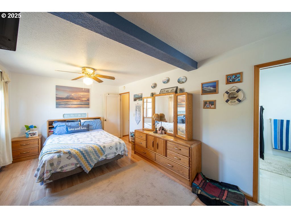 3689 Southeast 14th Street Gresham, OR 97080 - Photo 12 of 35 a bedroom with a bed next to a large window with the outer view