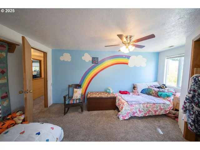 a bedroom with furniture and a wooden floor