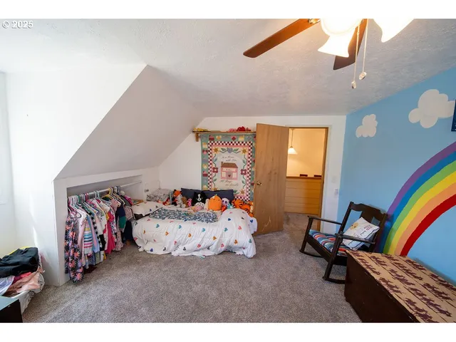 a bedroom with furniture and a large window