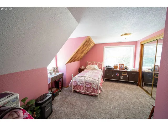 a bedroom with a bed and a table