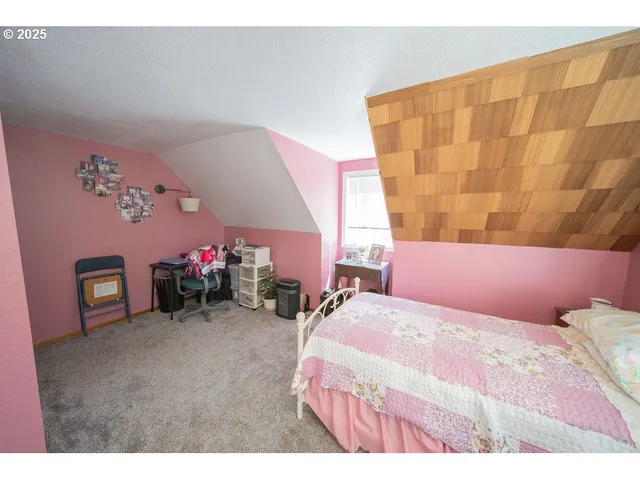 a living room with furniture a flat screen tv and a large window