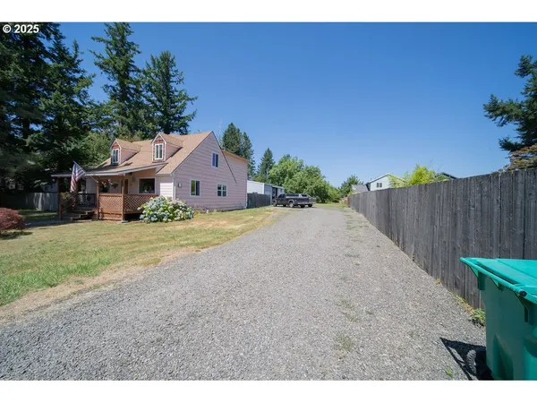 a view of an house with backyard space and garden