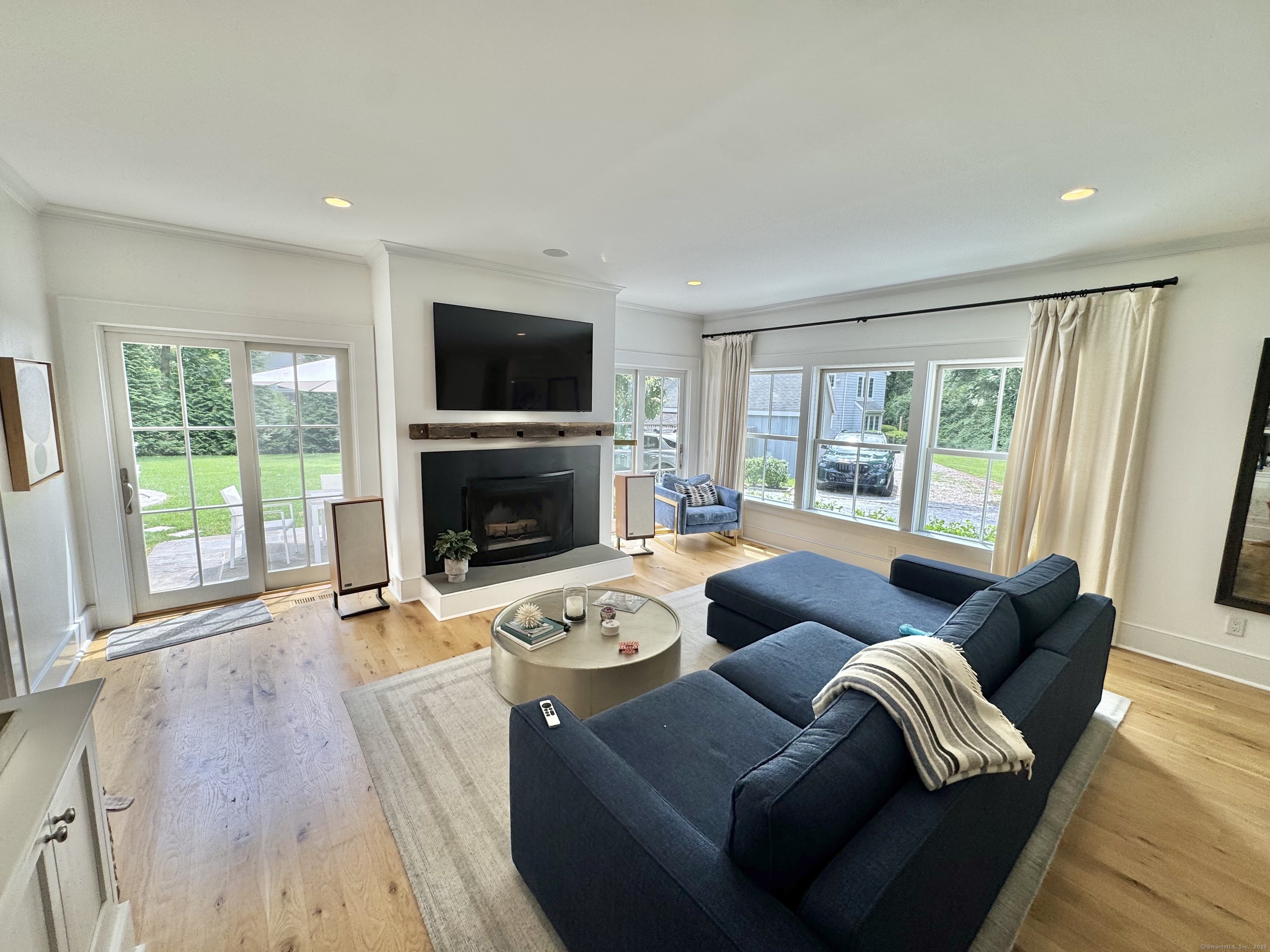 18 Englewood Road Norwalk, CT 06853 - Photo 13 of 25 a living room with furniture a flat screen tv and a fireplace