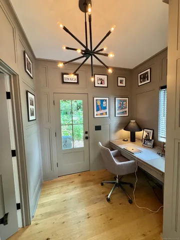 a workspace room with furniture and window