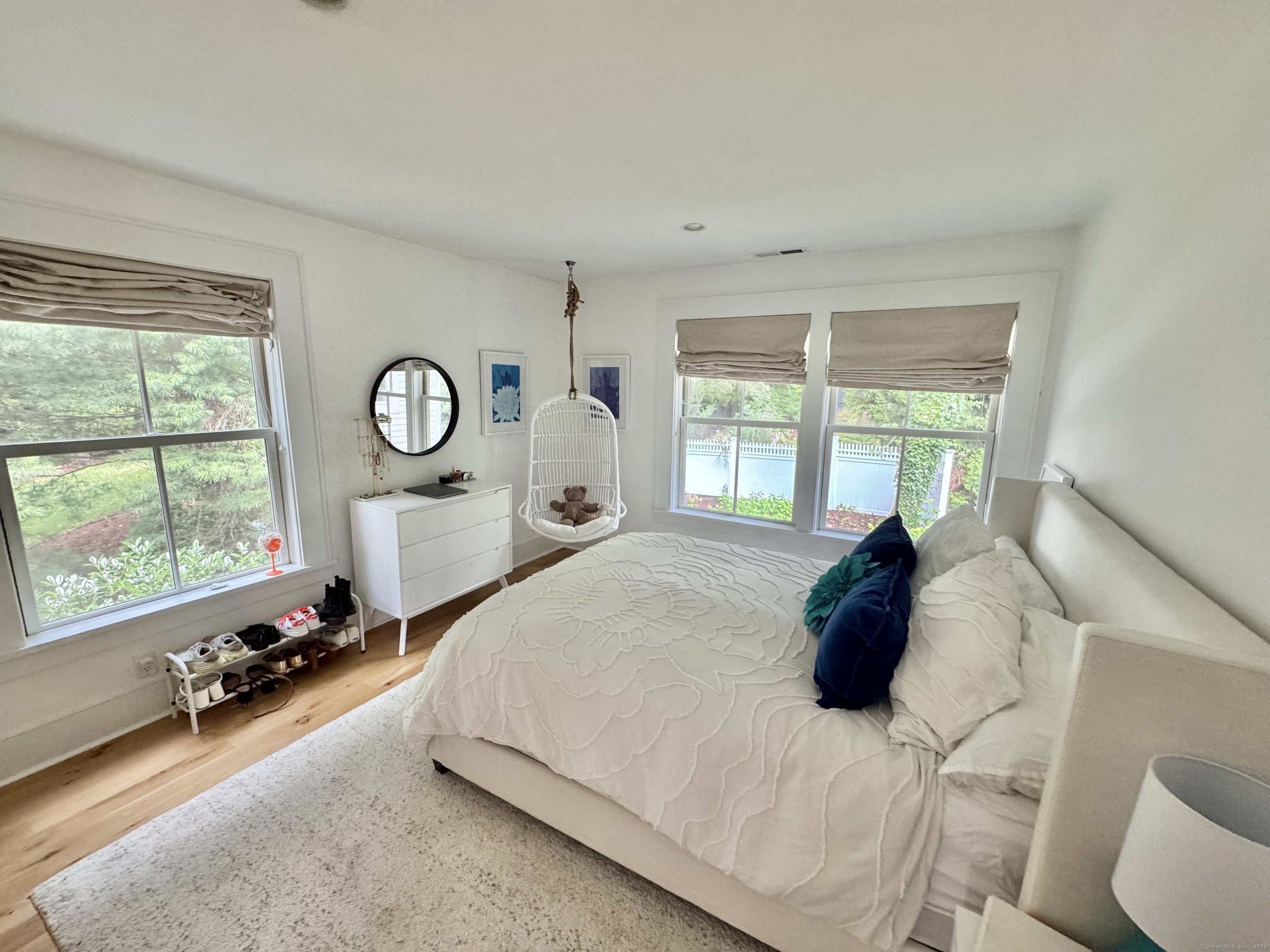 18 Englewood Road Norwalk, CT 06853 - Photo 21 of 25 a large bed sitting in a bedroom next to a window