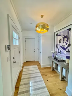 a view of a bedroom with wooden floor and bathroom