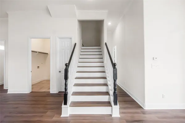 a view of entryway and hall with wooden floor