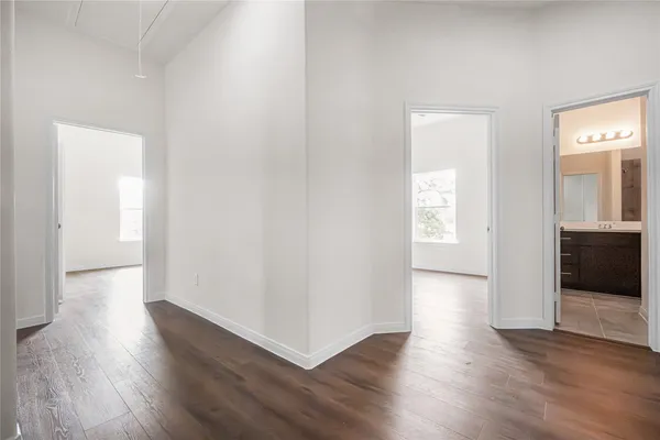 a view of a hallway with wooden floor