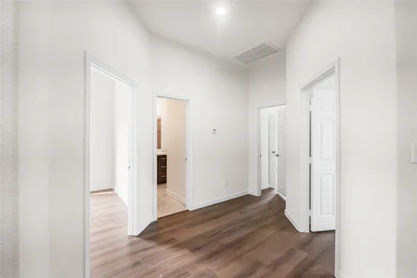 a view of hallway with wooden floor