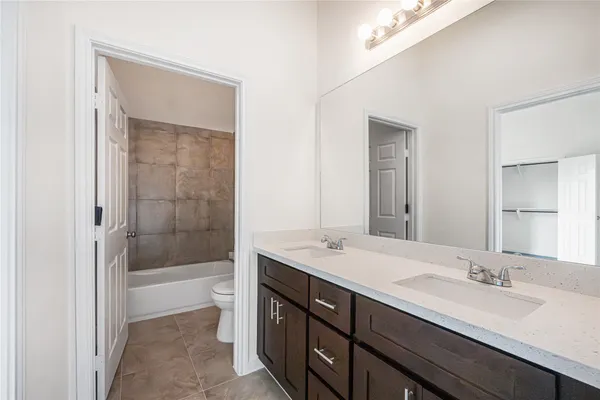 a bathroom with a sink a shower and a mirror