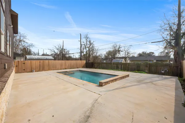a view of outdoor space with swimming pool and trees in the background