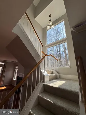 a view of staircase with white walls and a stairs