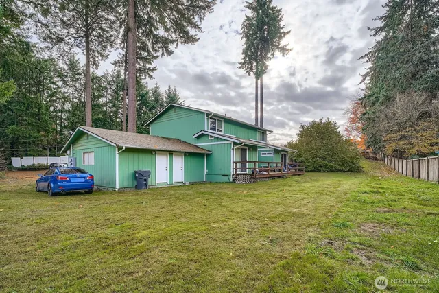 a view of a house with a yard and sitting area