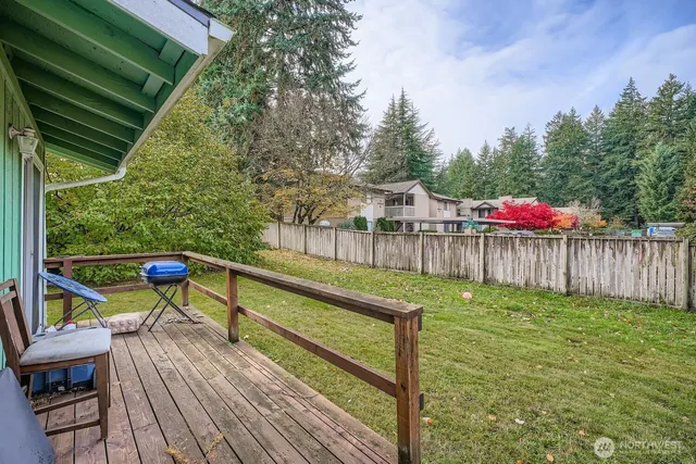 a view of a chairs and table on the wooden deck