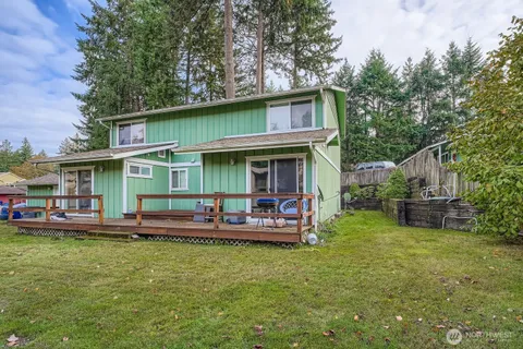 a view of a house with backyard porch and sitting area