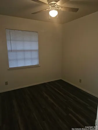 a view of a livingroom with wooden floor and a window