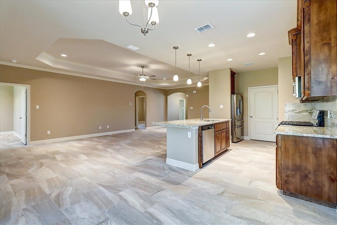 3153 Seawolf Corpus Christi, TX 78414 - Photo 20 of 40 a large kitchen with stainless steel appliances kitchen island a large counter top and a stove top oven