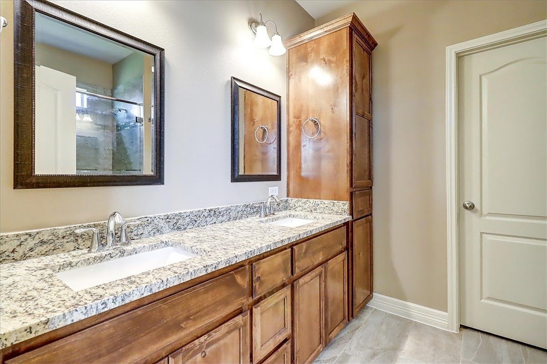 3153 Seawolf Corpus Christi, TX 78414 - Photo 25 of 40 a bathroom with a granite countertop sink and a mirror