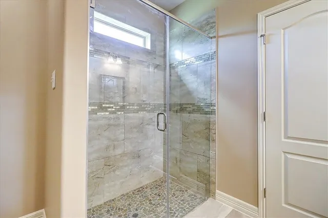 a bathroom with a glass shower door