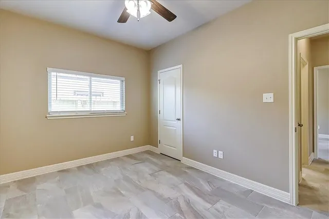 an empty room with windows and closet