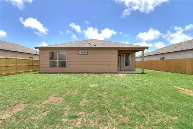 a view of a house with a backyard