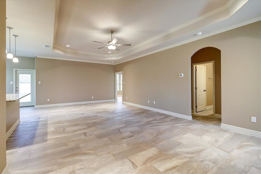 3153 Seawolf Corpus Christi, TX 78414 - Photo 6 of 40 a view of an empty room with chandelier fan and kitchen view