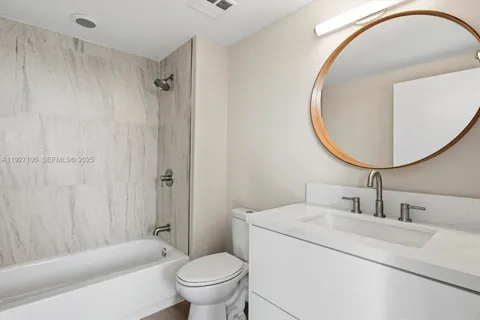 a kitchen with a refrigerator sink and cabinets