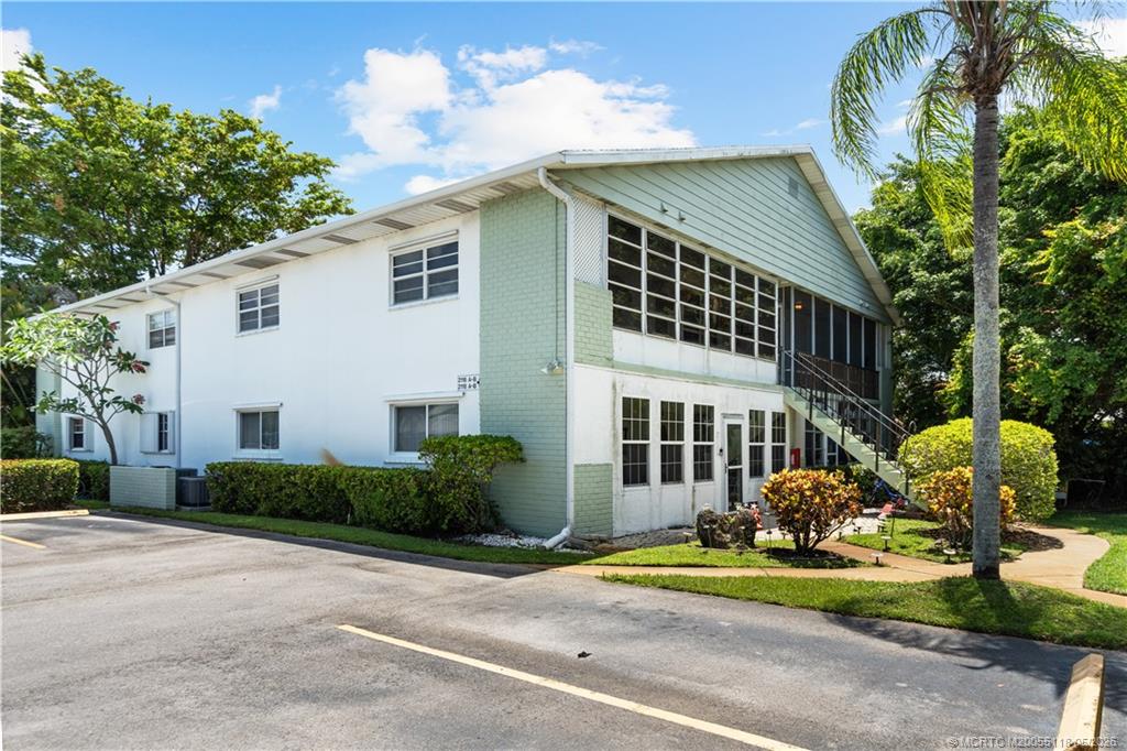 2118 Southeast Edler Drive, Unit B Stuart, FL 34994 - Photo 20 of 20 a front view of a house with garden and plants