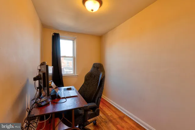 a view of a workspace with furniture and a window