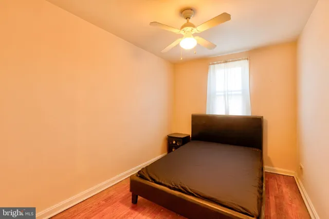 a room with a bed and a ceiling fan